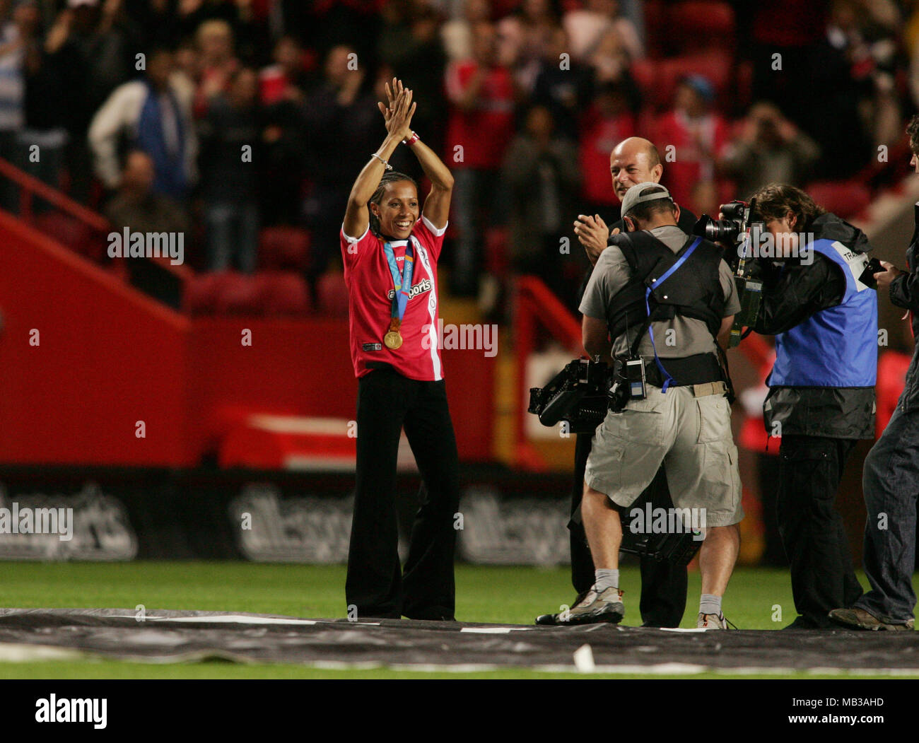Kelly Holmes walks on the Charlton FC pitch to greet fans showing off her two Gold Medals Stock Photo