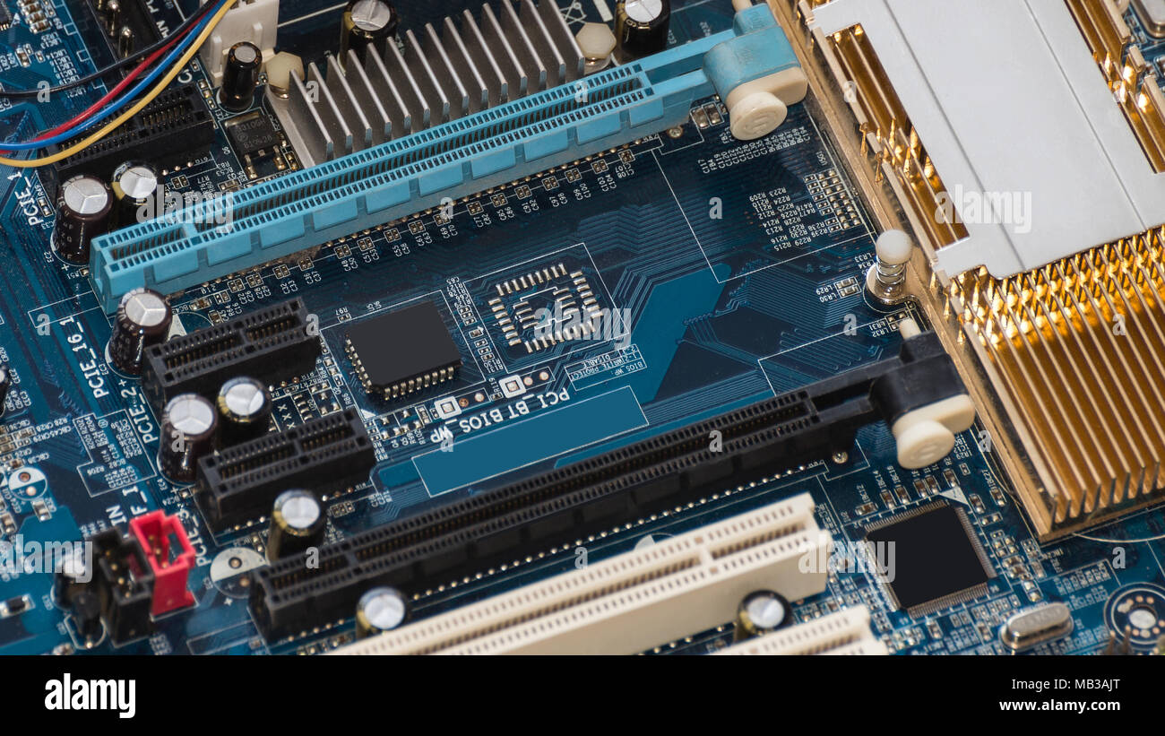 Motherboard with PCI express slot and a standard PCI slot. Visible heat sink Stock Photo