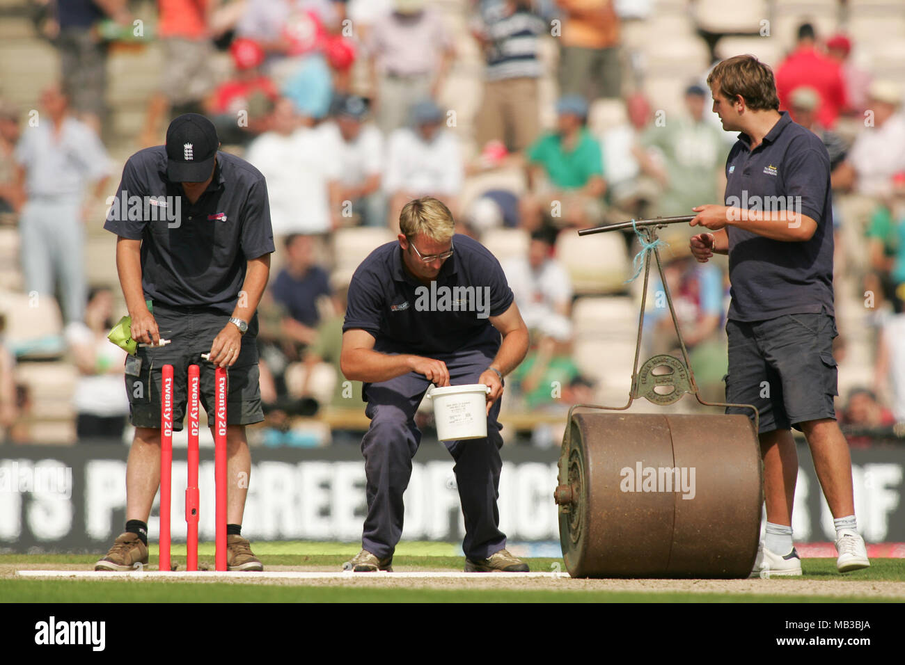 Groundsman at the Hampshire Rose bowl in Southampton prepare the wicket and mark out the stumps for a cricket match. Stock Photo