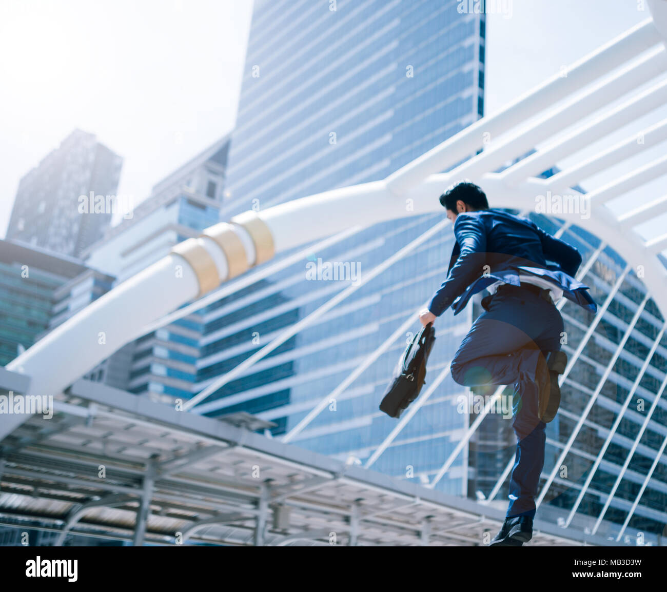 jumping running business man in front of buildings stock photo
