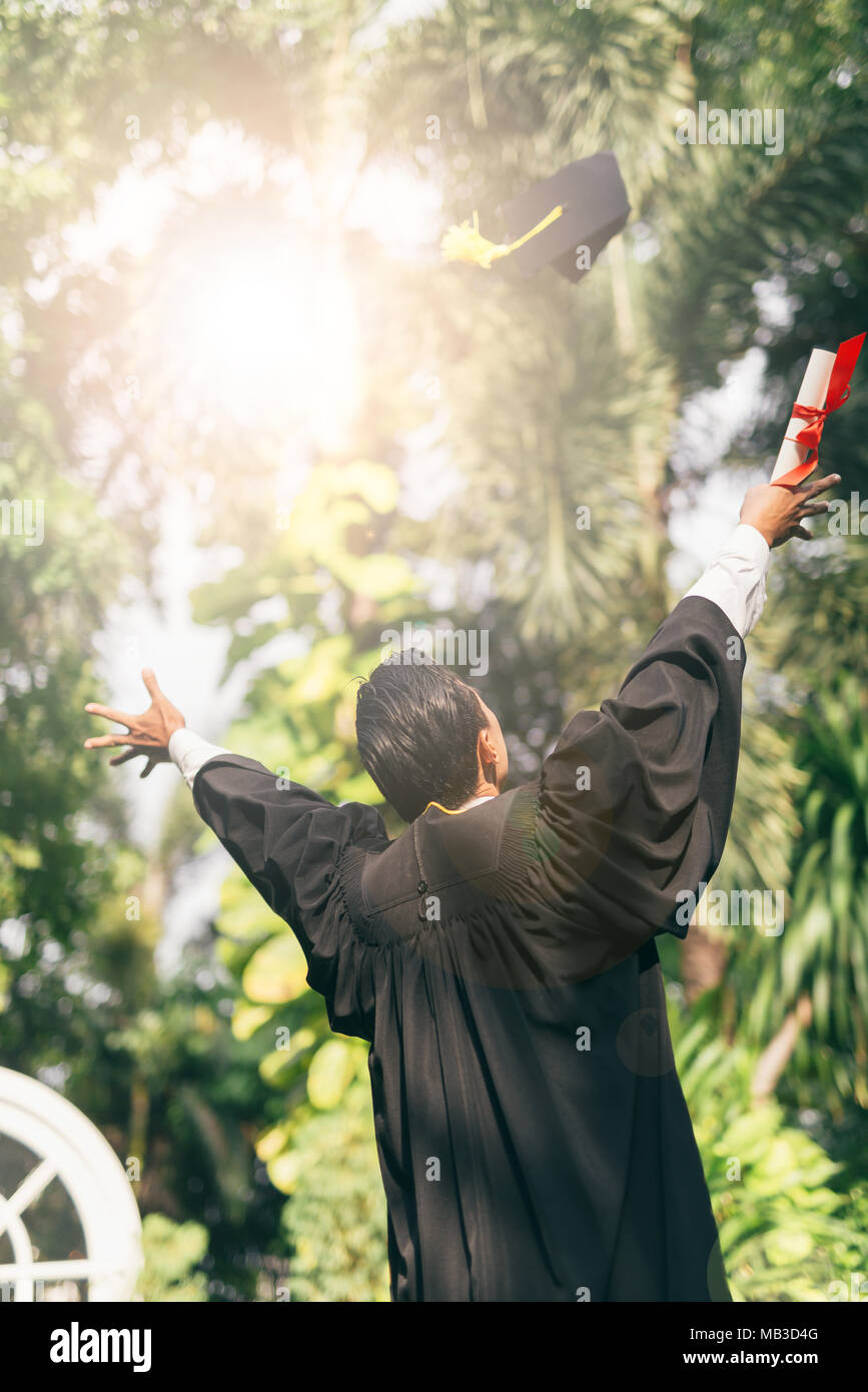 Graduate man students , back view of graduation day University ...