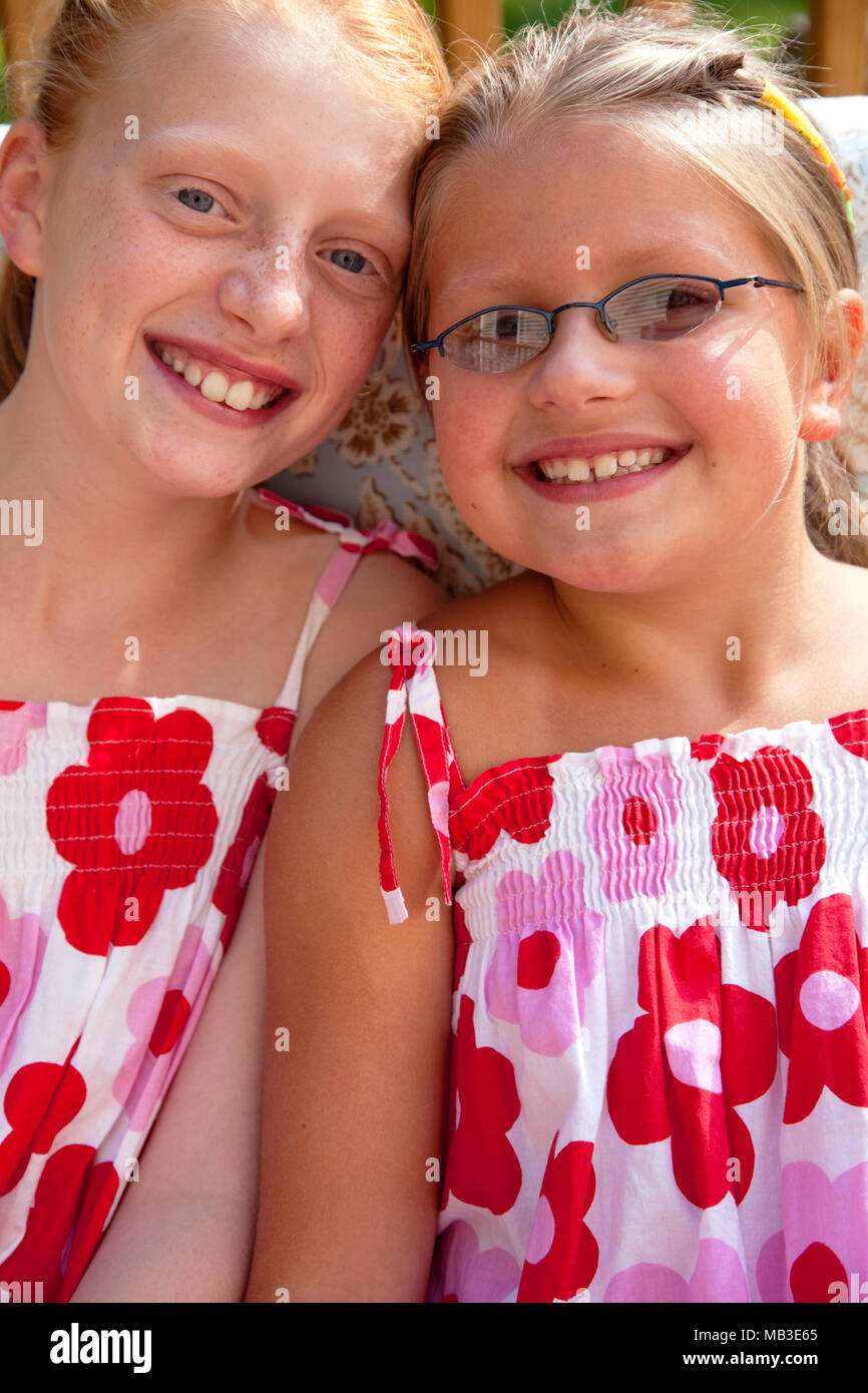 Smiling Girls in Matching Dresses Stock Photo Alamy