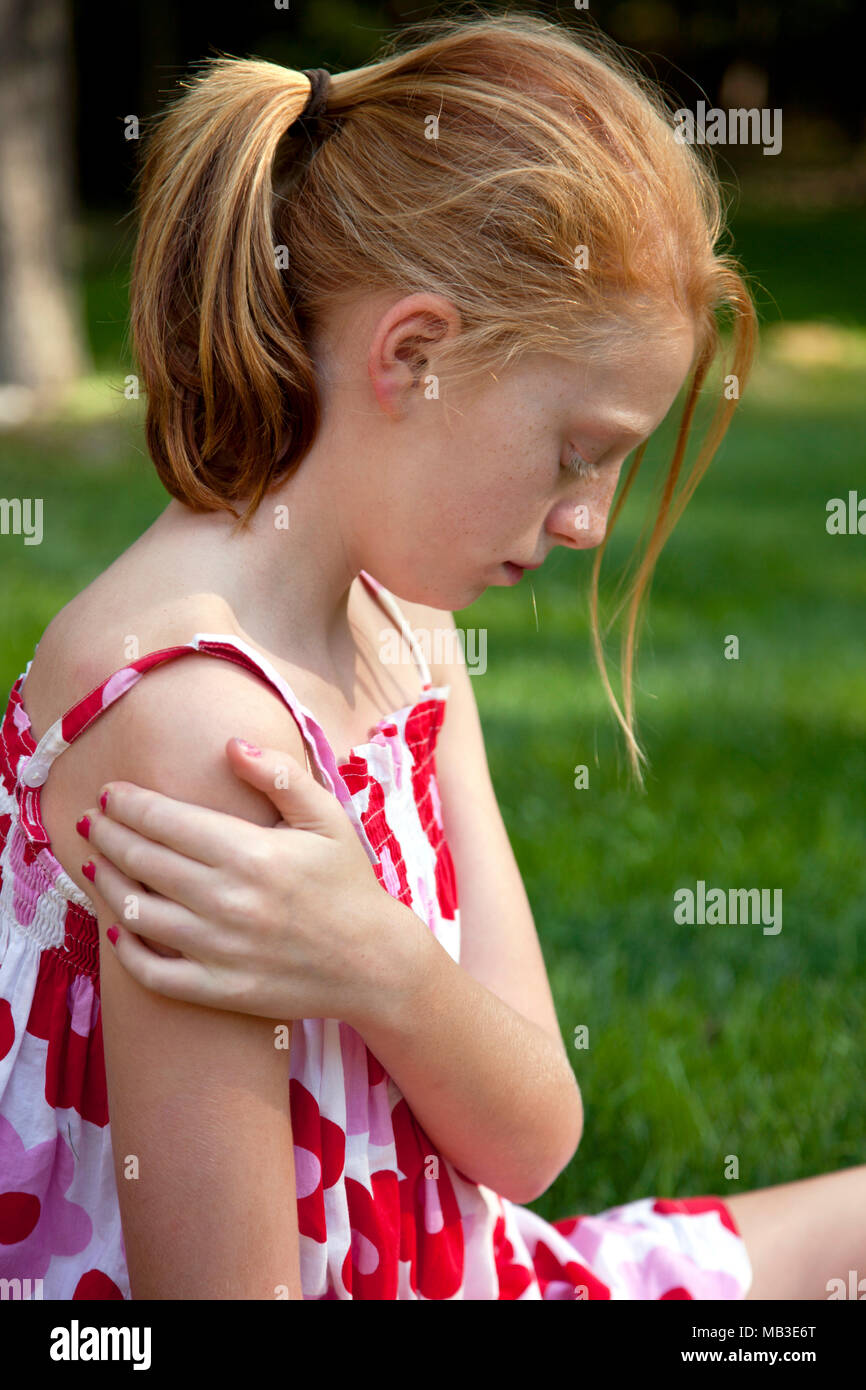 Sad Young Girl Looking Down Stock Photo