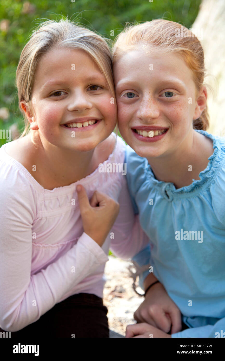 Two Smiling Young Girls in Pink and Blue Stock Photo
