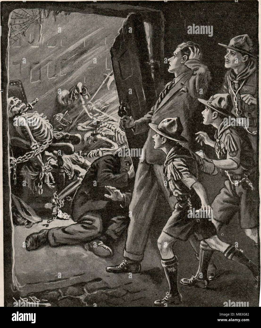 An Illustration from the Boys own annual 1932-33 (UK) showing boy scouts discovering a pile of chained skeletons Stock Photo