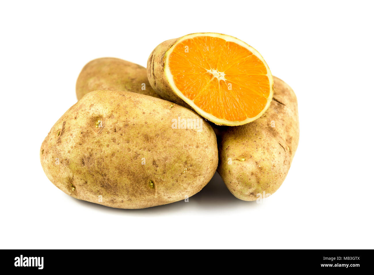 Eat your veggies! a sliced potato reveals the flesh of a fresh Orange Stock Photo