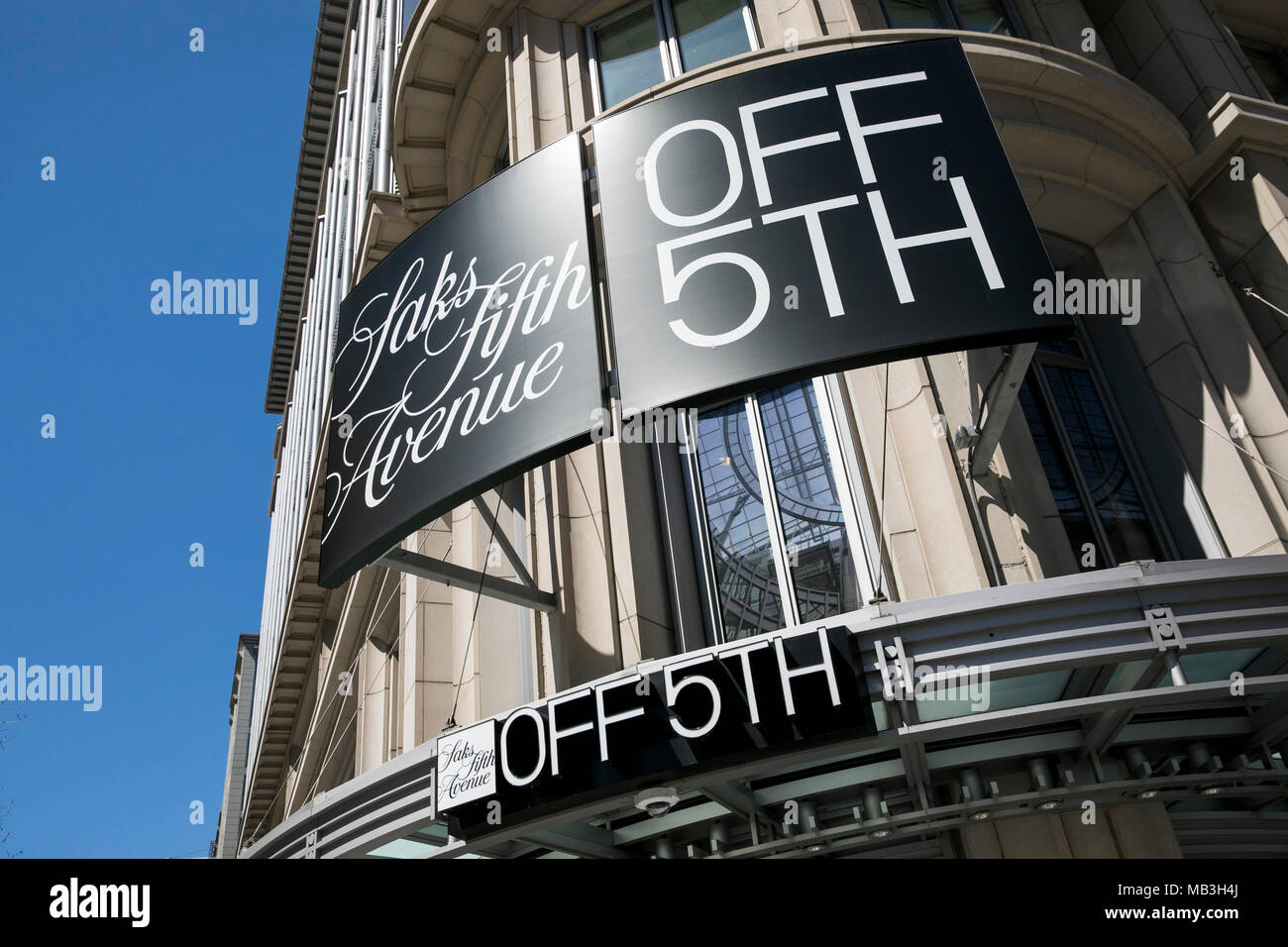 A logo sign outside of a Saks Fifth Avenue Off 5th retail store in downtown Washington, D.C., on March 31, 2018. Stock Photo