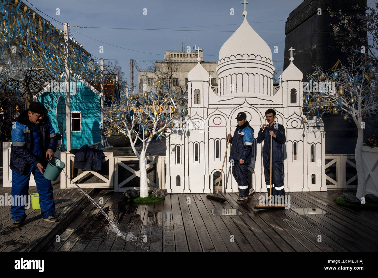 Employees of city municipal service wash a pavement near the model of the Cathedral of Christ the Savior on Tverskaya Square in Moscow during festiva Stock Photo