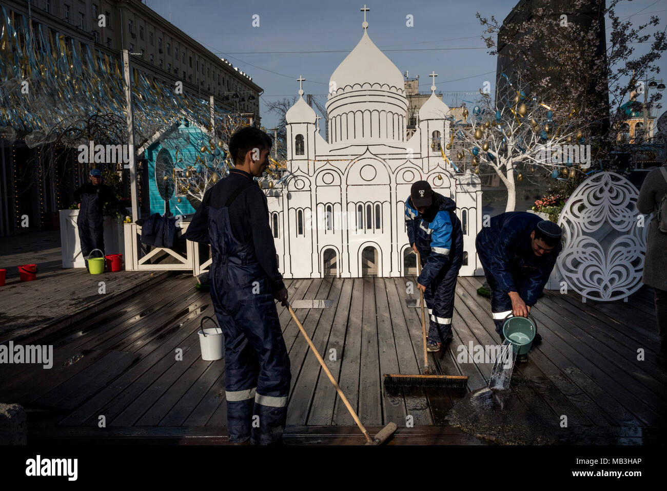 Employees of city municipal service wash a pavement near the model of the Cathedral of Christ the Savior on Tverskaya Square in Moscow during festiva Stock Photo