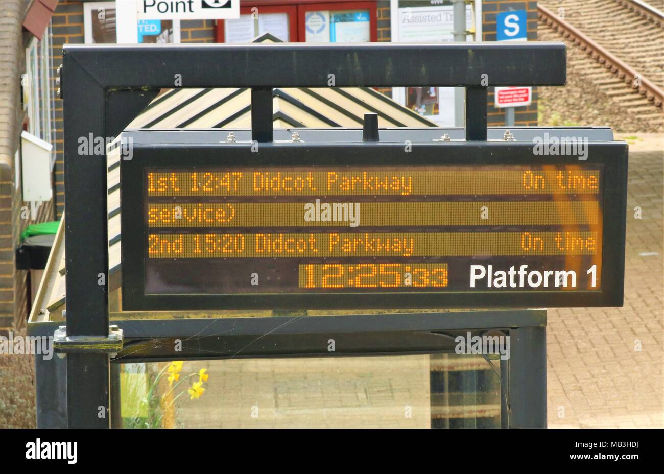 Electronic information board on platform 1 at Heyford Railway Station, Oxfordshire, UK displaying Didcot Parkway on time at 12.25 Stock Photo