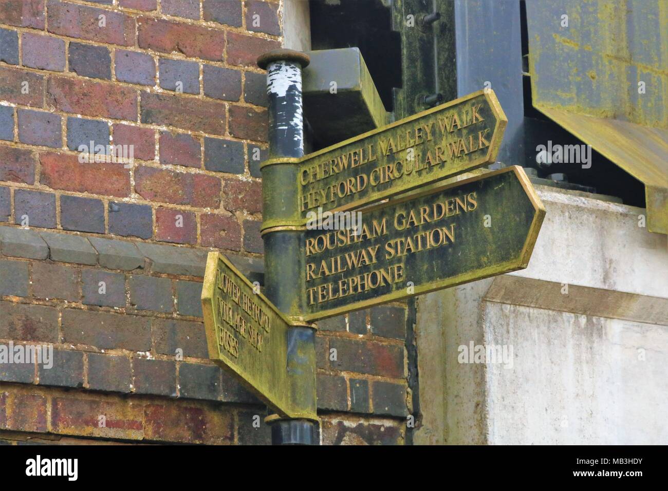 Cherwell Valley Walk, Heyford Circular Walk, Rousham Gardens, Railway Station, Telephone, Lower Heyford, Village Shop, Buses' old style sign Stock Photo