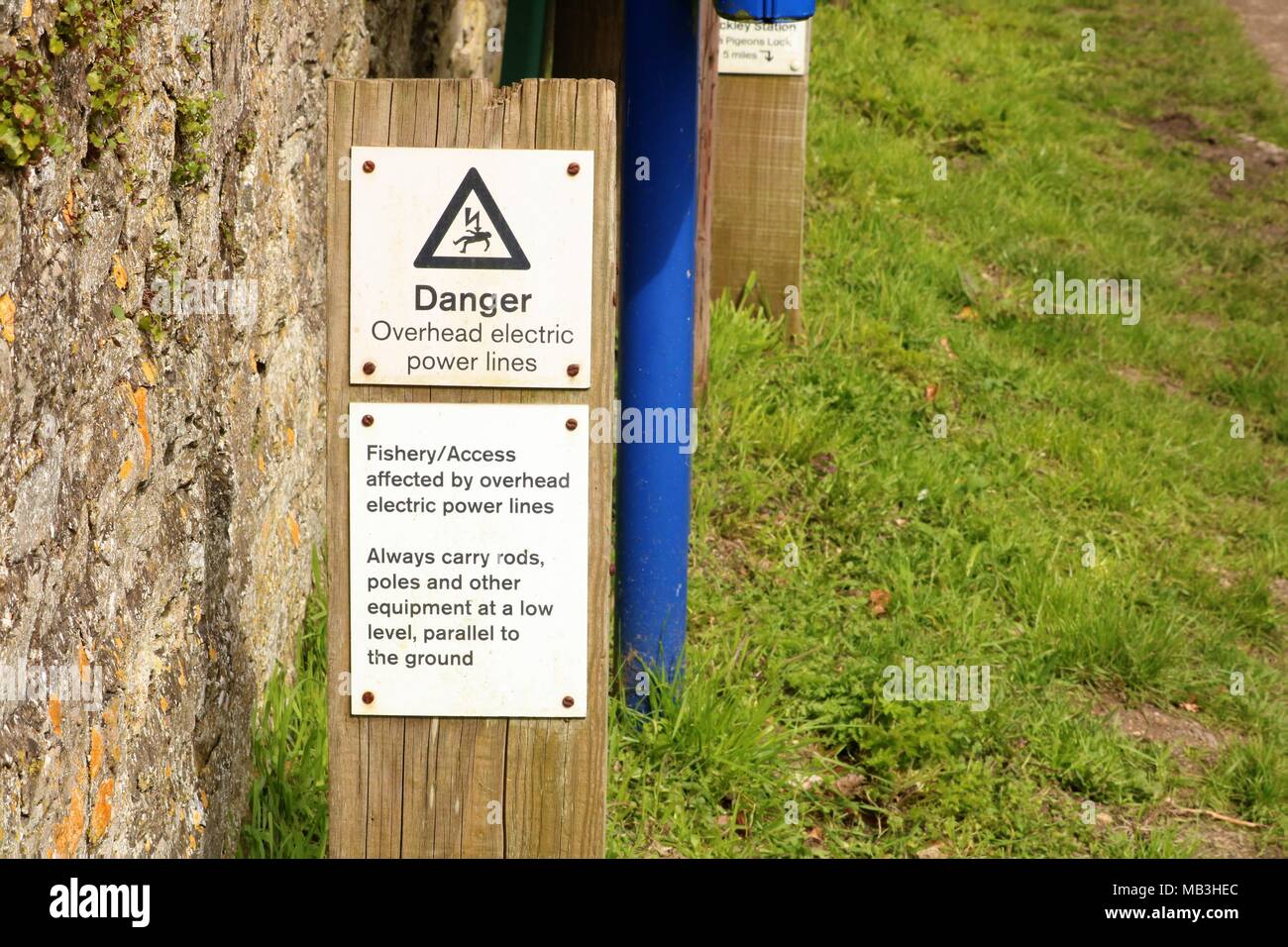 'Danger Overhead electric power lines' 'Fishery / Access affected by overhead electric power lines' 'Always carry rods, poles and other equipment Stock Photo