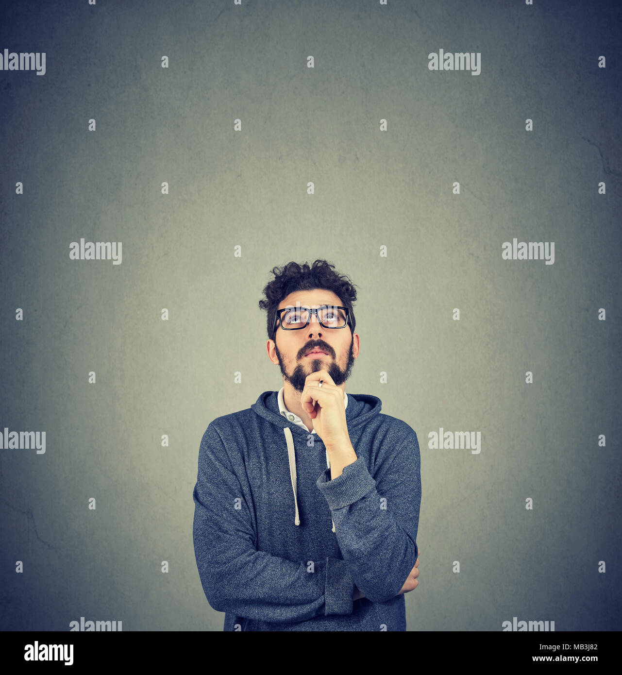 handsome hipster man thinking looking up Stock Photo