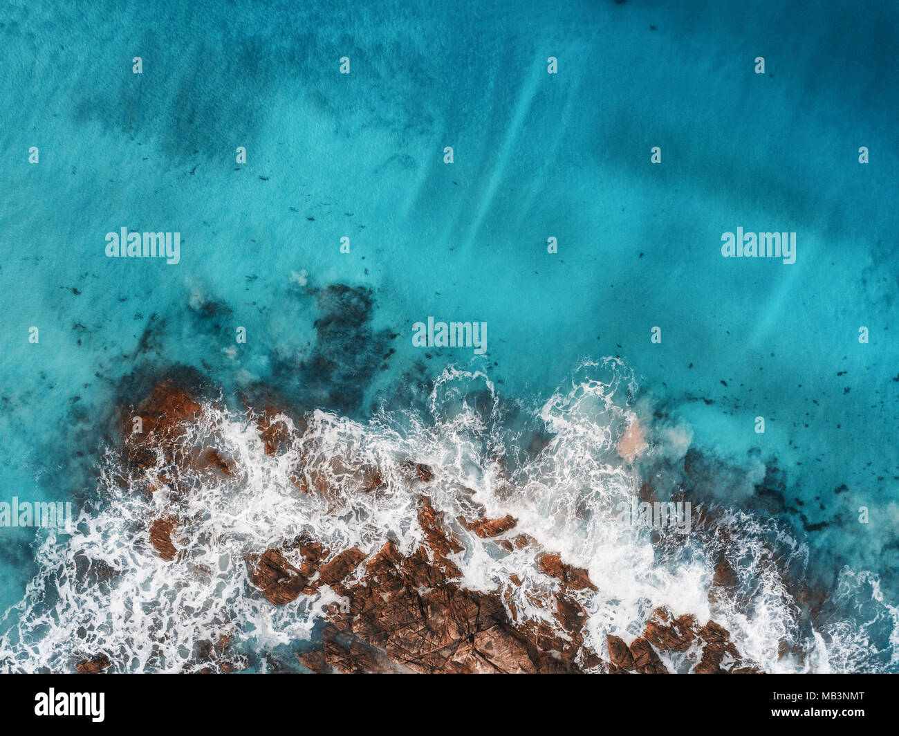 Aerial view of waves, rocks and transparent sea. Summer seascape with ...