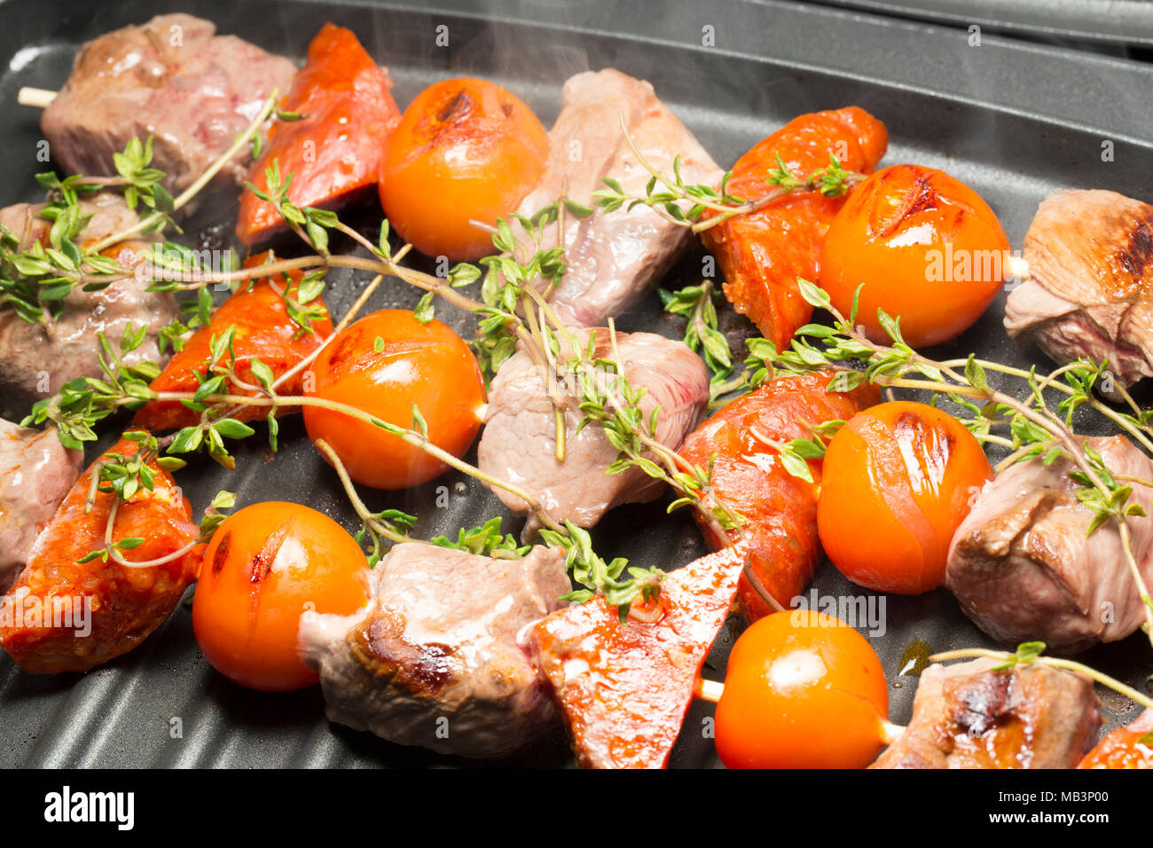 Wild boar, chorizo sausage and cherry tomatoes and thyme, cooked on a