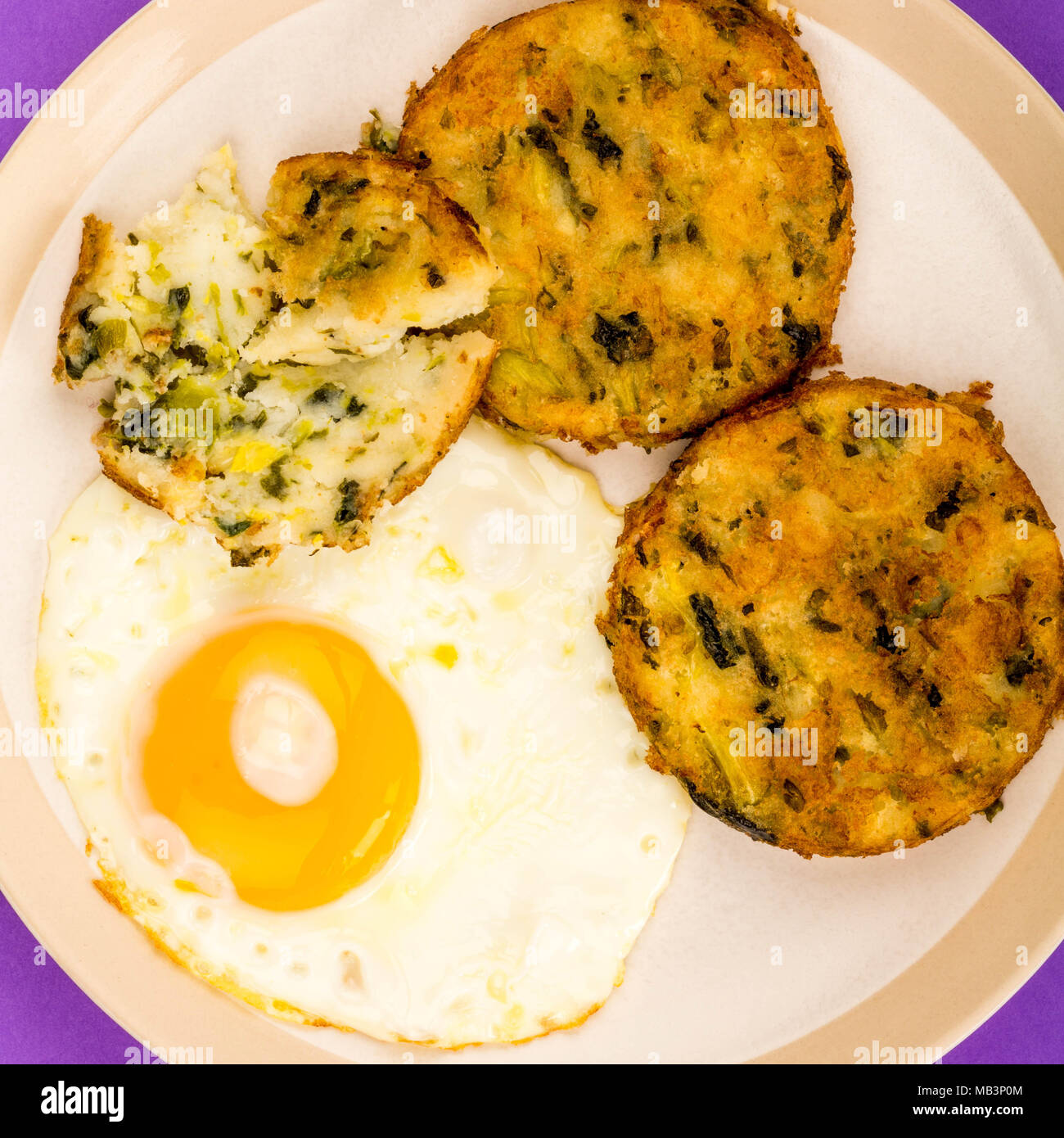 Fried Egg on a Plate With Bubble and Squeak Patties Meal Stock Photo