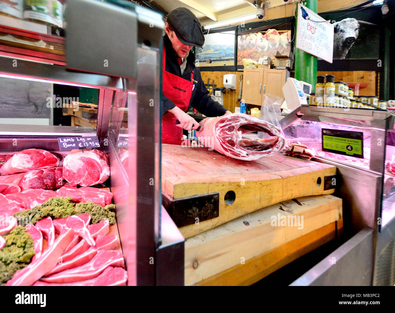 London, England, UK. Man butchering meat in Borough Market, Southwark Stock Photo