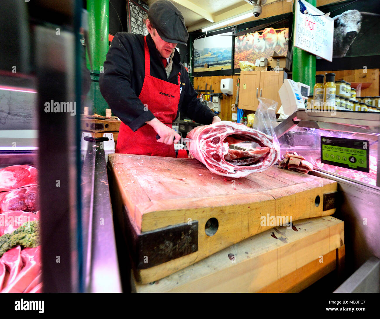 London, England, UK. Man butchering meat in Borough Market, Southwark Stock Photo