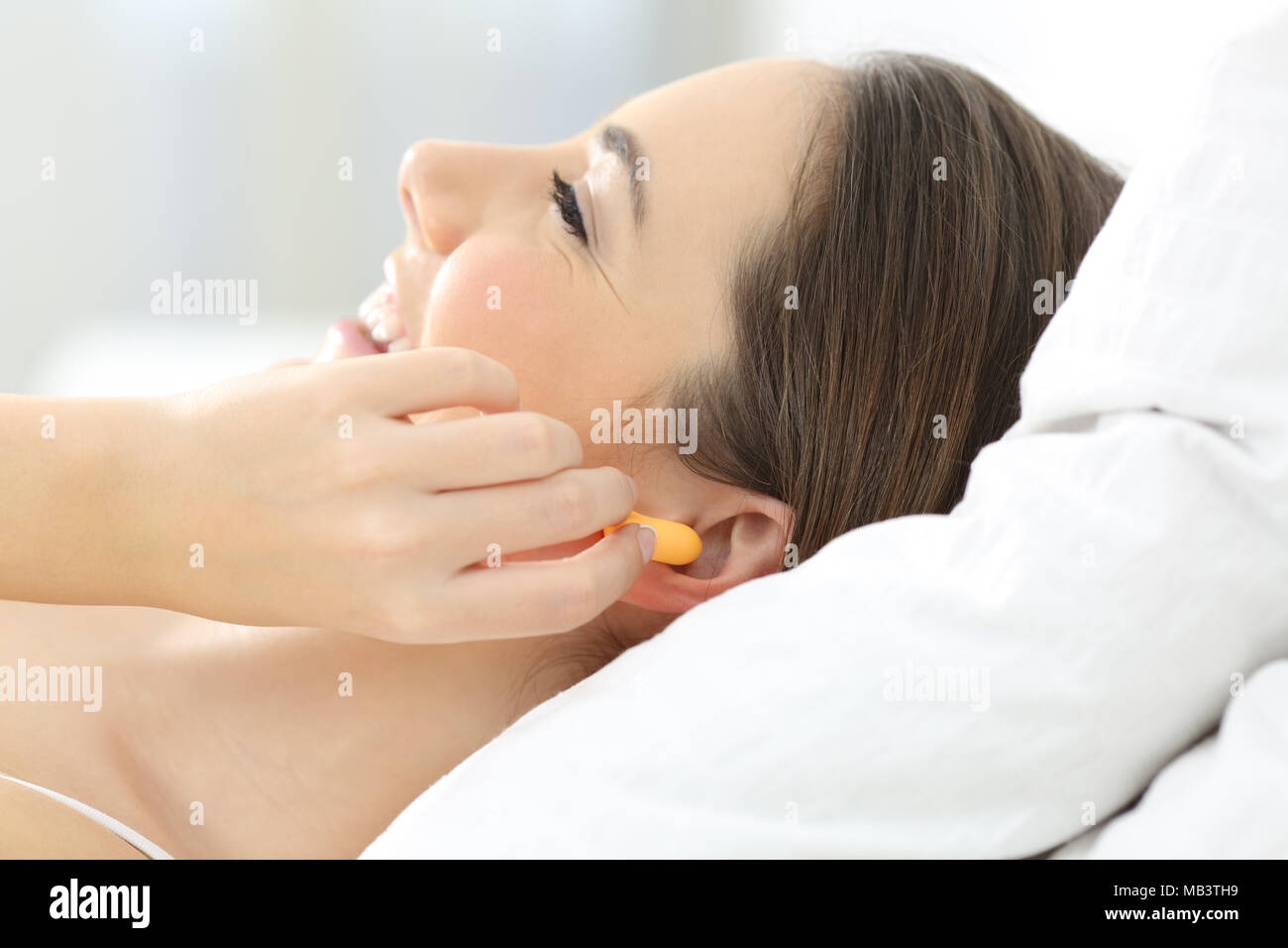 Woman wearing ear plugs hires stock photography and images Alamy