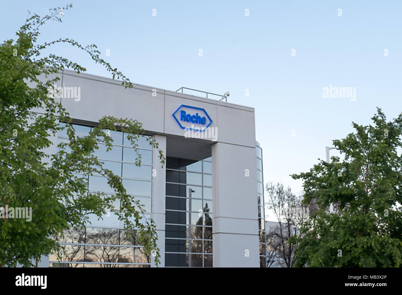 Facade with sign and logo at regional headquarters of pharmaceutical company Roche in Pleasanton, California, March 26, 2018. () Stock Photo