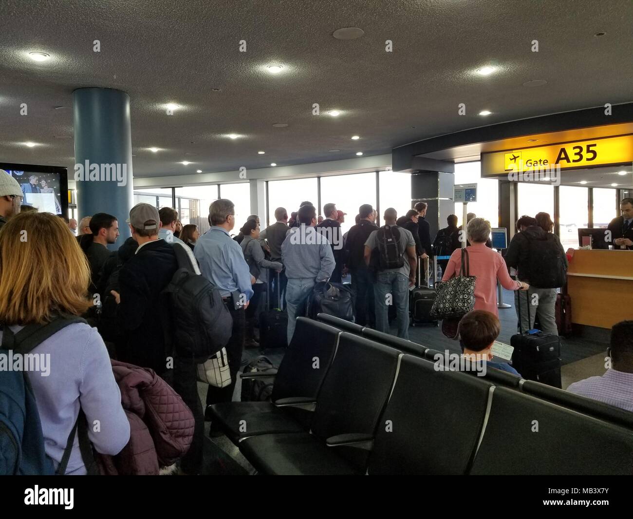 A long line of travelers waits to board a flight at Newark International Airport, Newark, New Jersey, March 22, 2018. () Stock Photo
