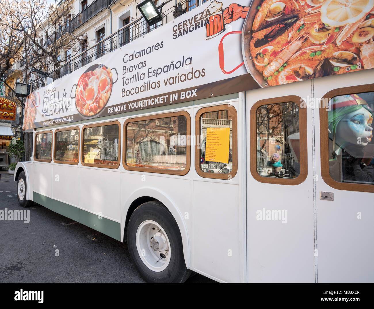 Street food stand inside white London bus in Valencia Spain Stock Photo