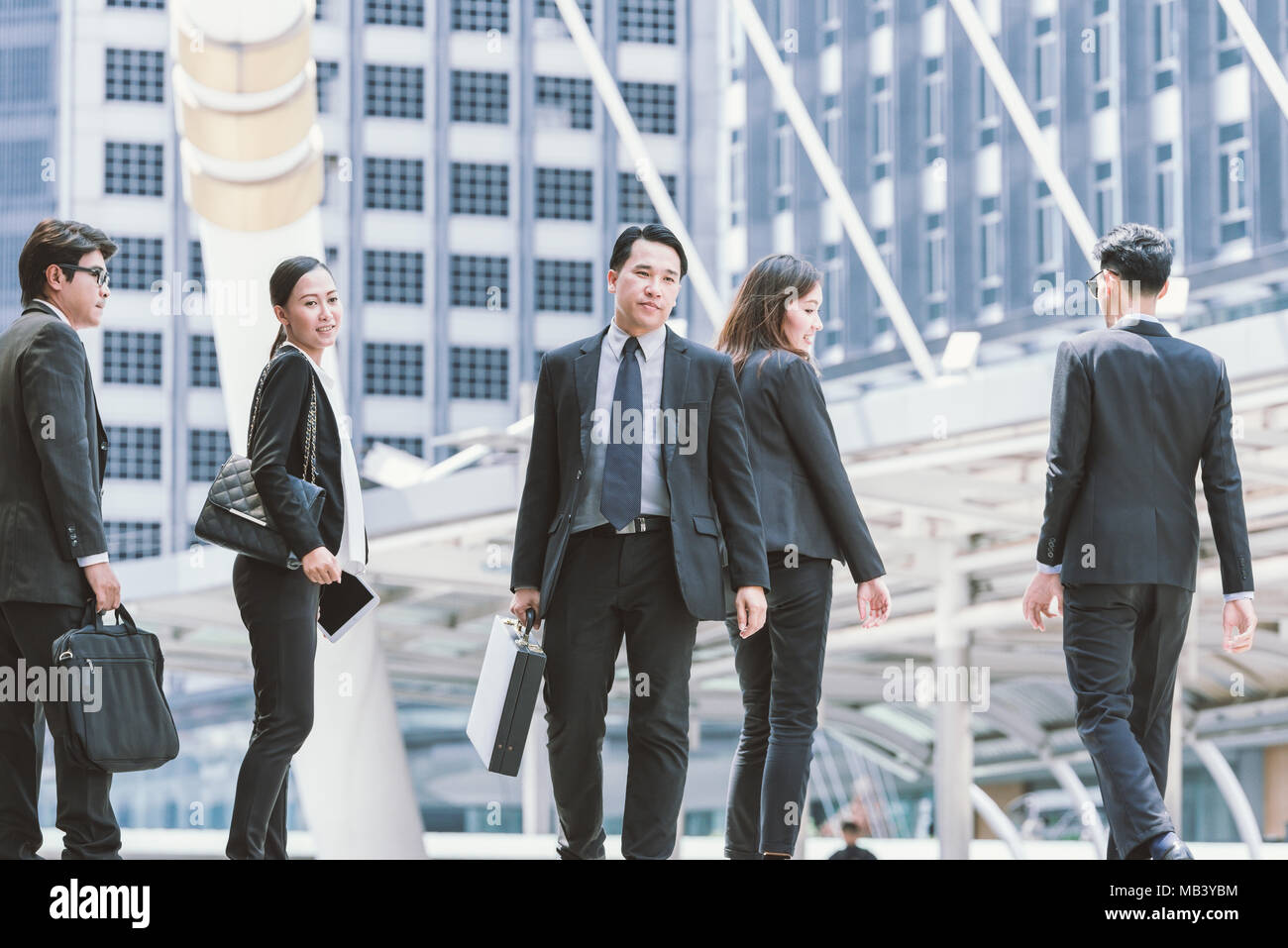 Group of happy business people walking together on street Stock Photo ...