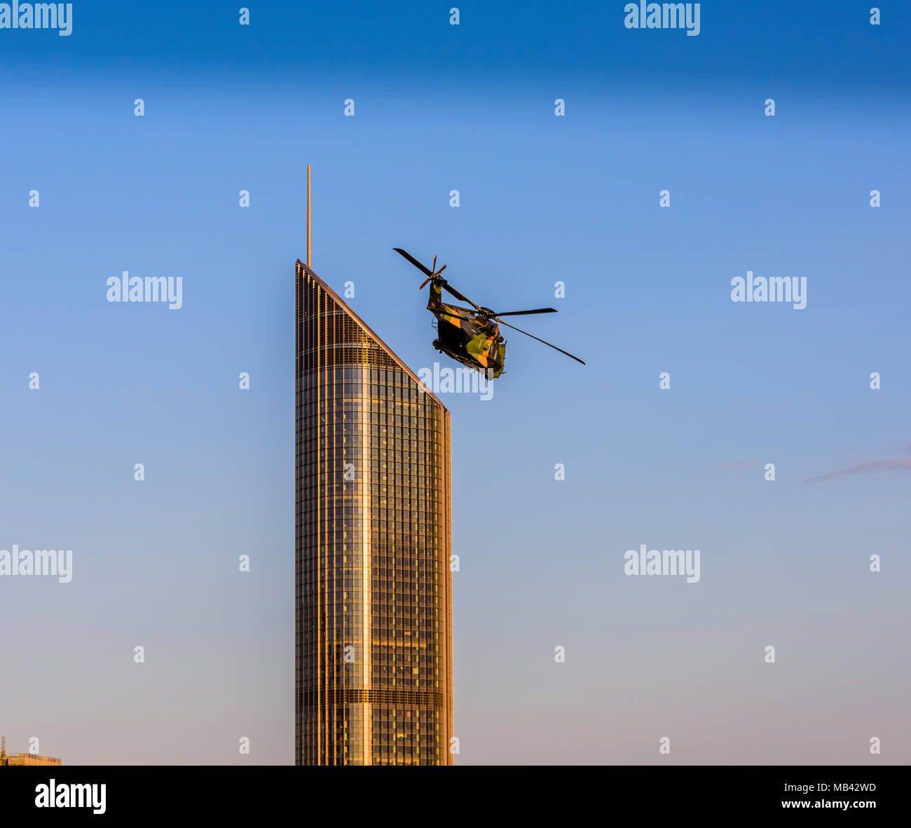 An Australian army helicopter flies over the 1 William Street building during the 2017 Riverfire in Brisbane, Queensland. Stock Photo