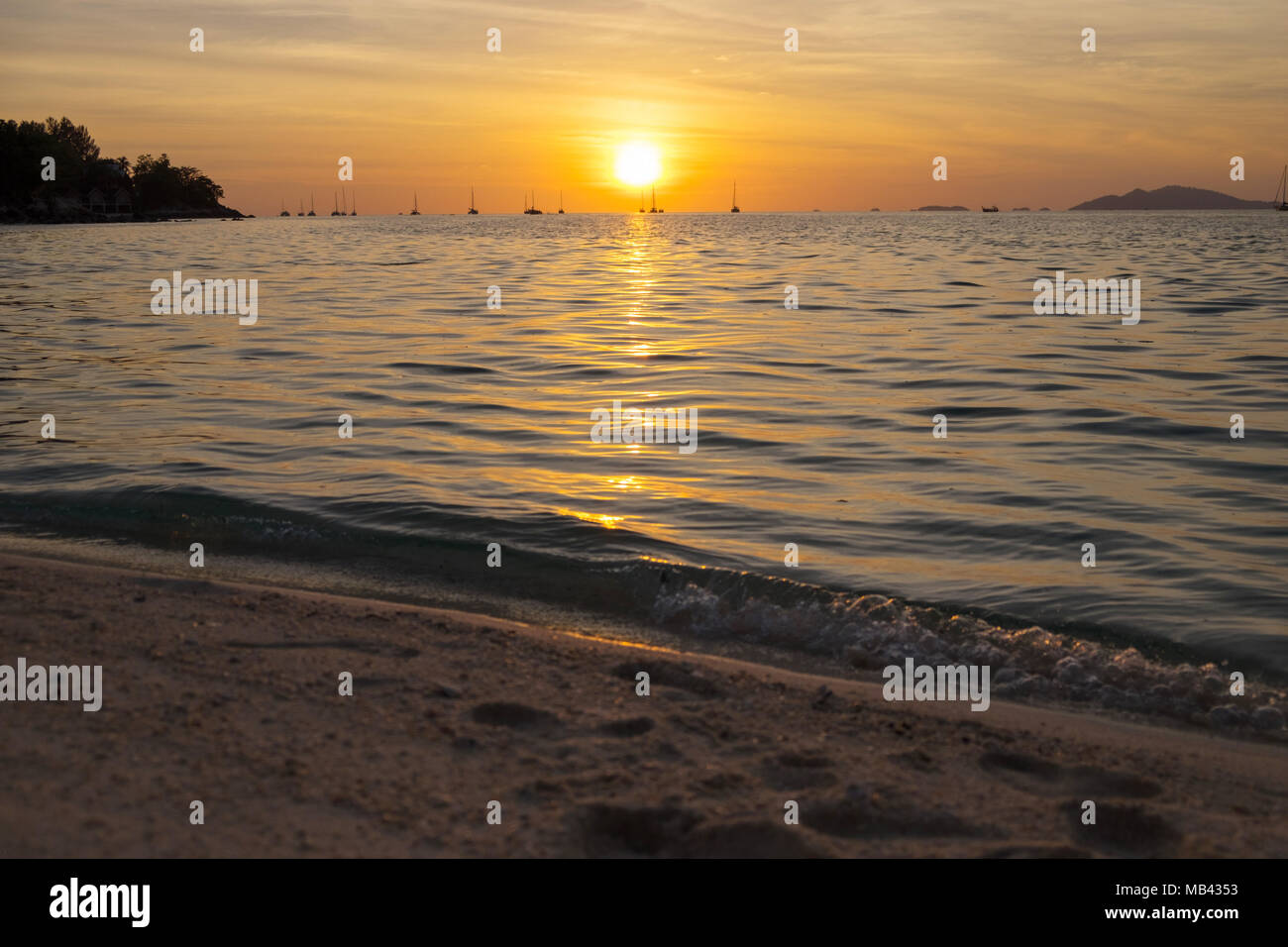 Beautiful sunset above the sea beach Stock Photo - Alamy