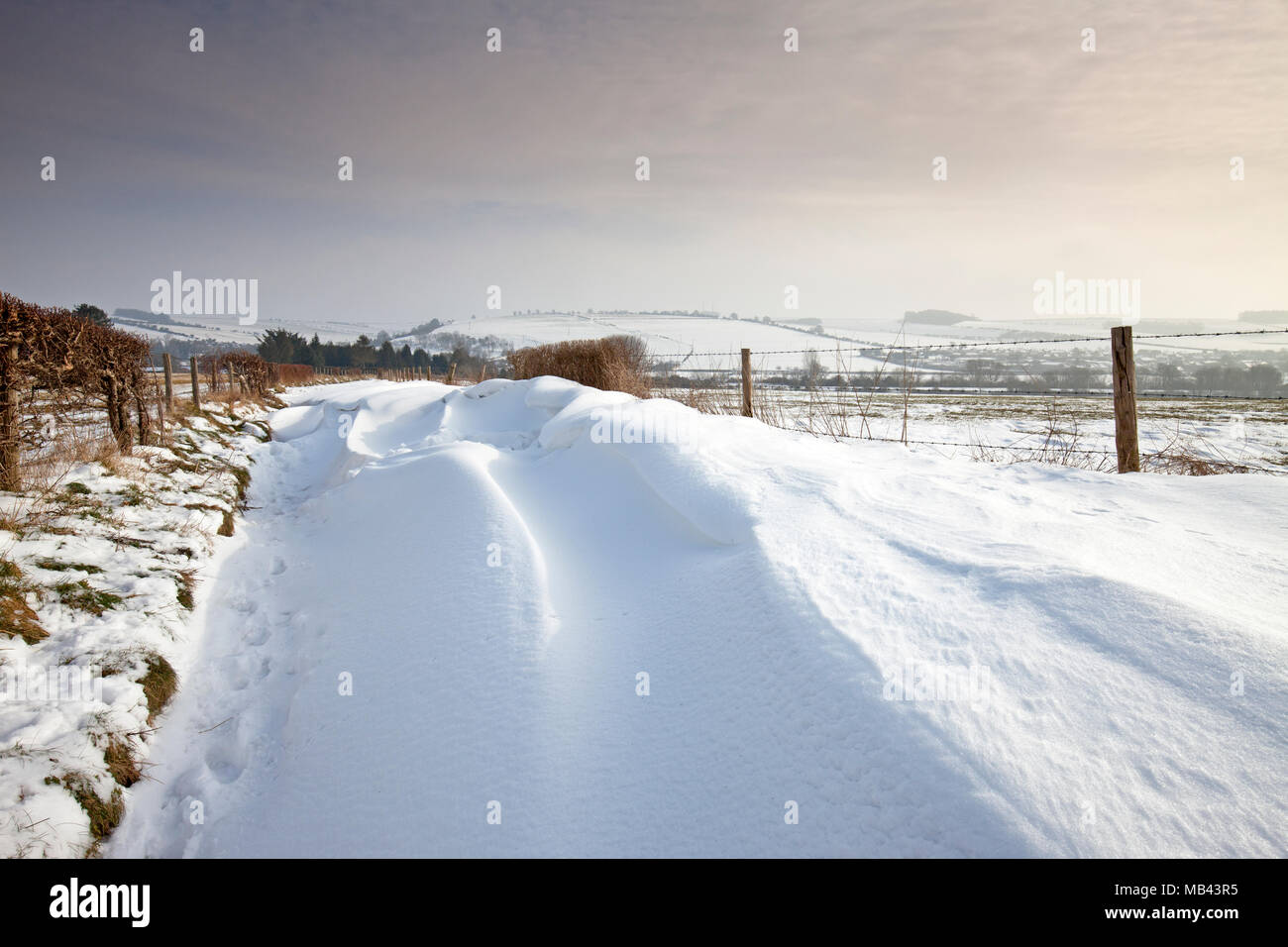 Snowdrifts on the track to Hadden Hill near Great Wishford in Wiltshire. Stock Photo