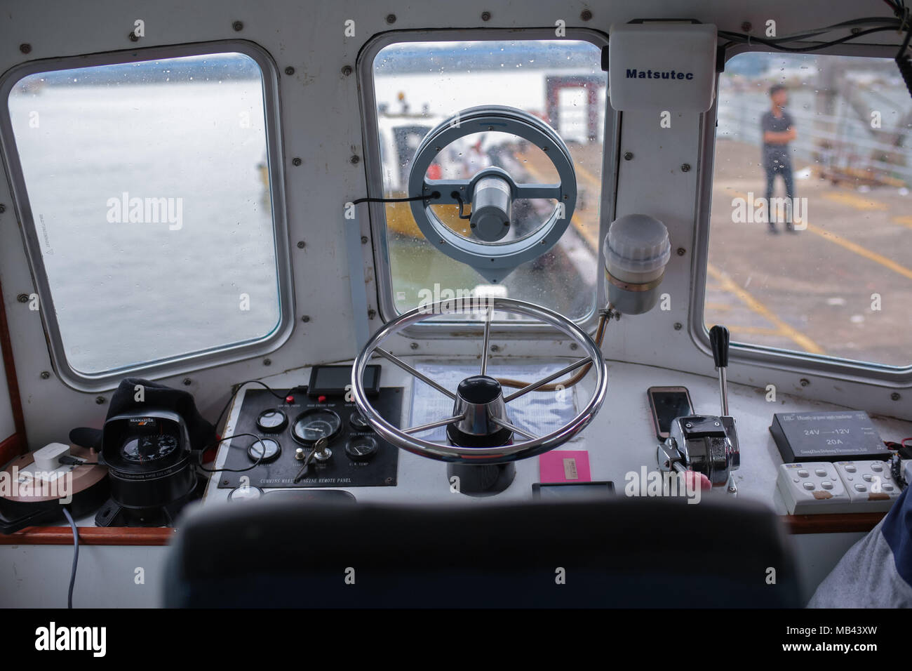 Boat operator at the helm of a private sea boat Stock Photo Alamy