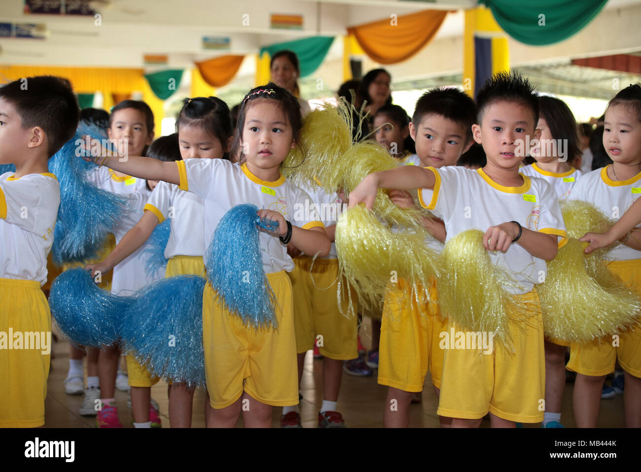 Children performance pom-pom dance at their kindergarten sport day activity. Stock Photo