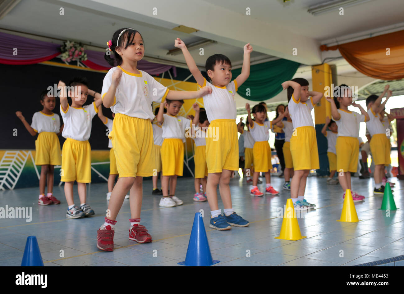 Children are performing dance at their kindergarten sport day. Stock Photo