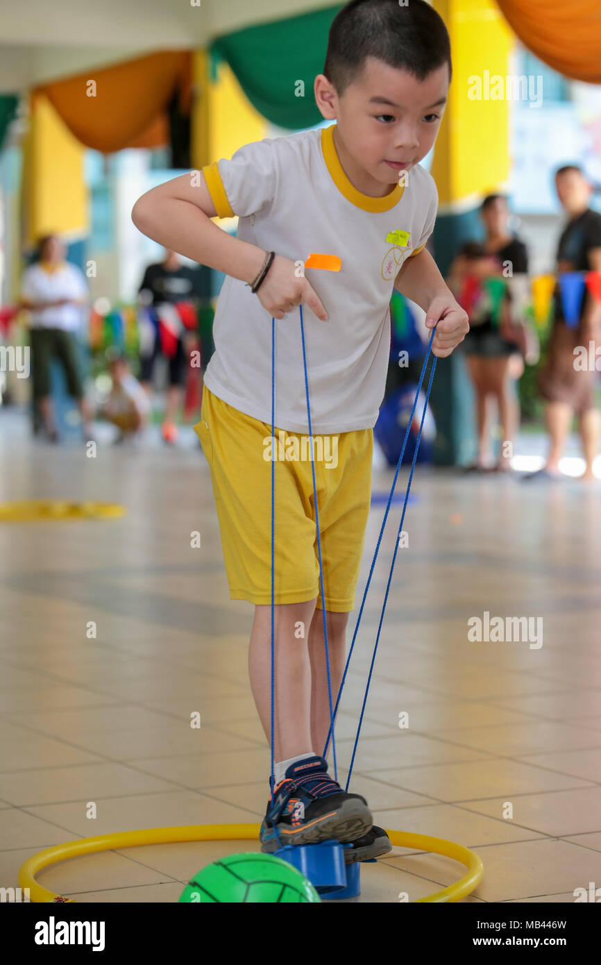Children playing the walk the clog game at their kindergarten sport day. Stock Photo