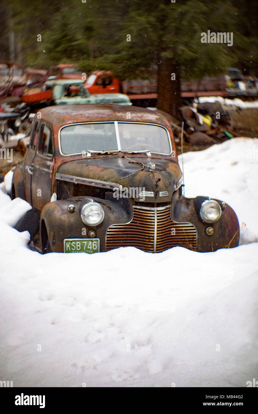 A Black 1940 Chevrolet Special Deluxe 4 Door Sedan Behind A Barn