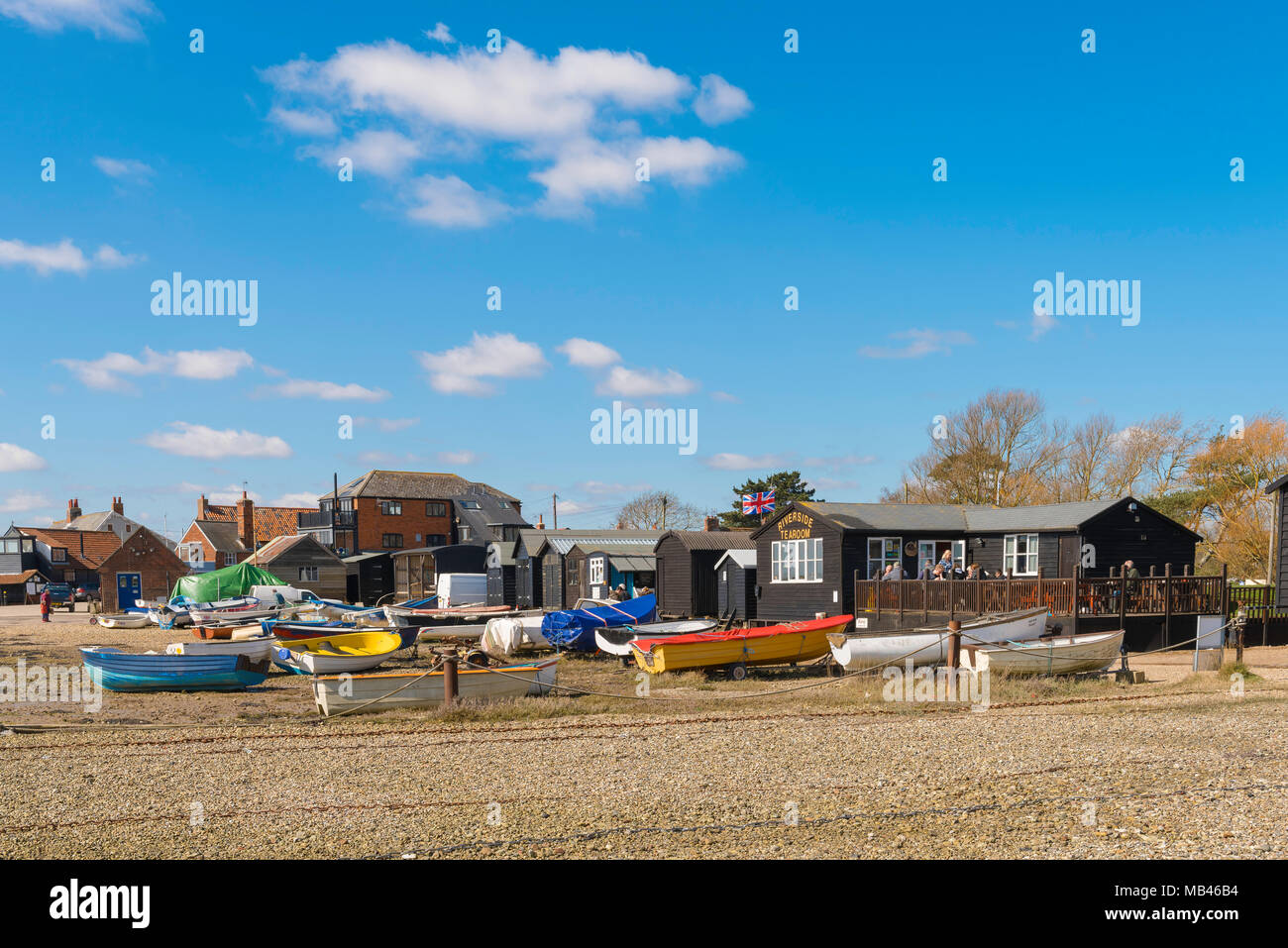 Suffolk beach UK, view of colourful boats and a tea shop on the beach at Orford quay, Suffolk, East Anglia, England, UK. Stock Photo