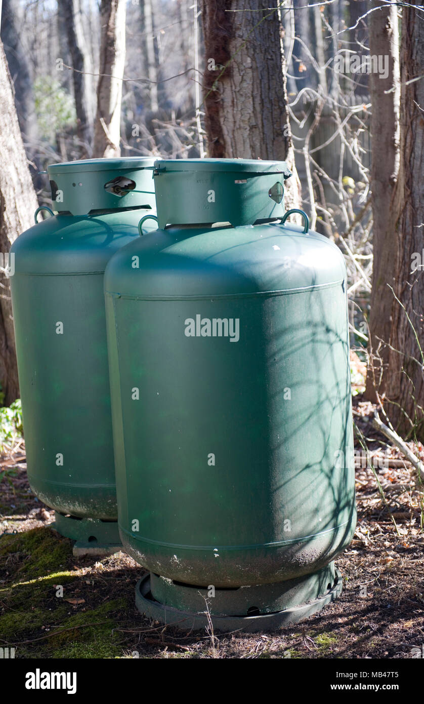 propane gas tanks for swimming pool heater in woods private house Stock