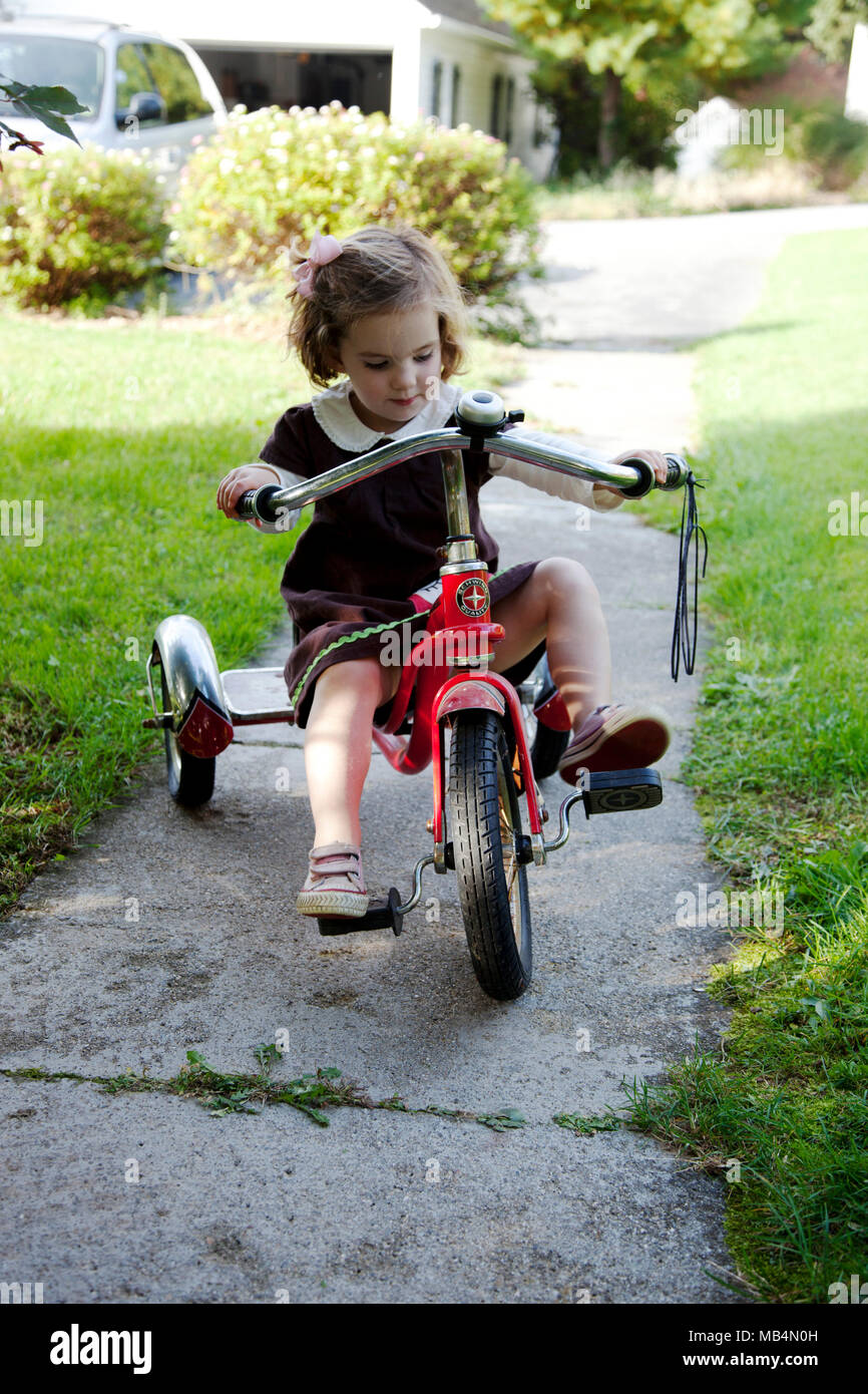 girl riding tricycle