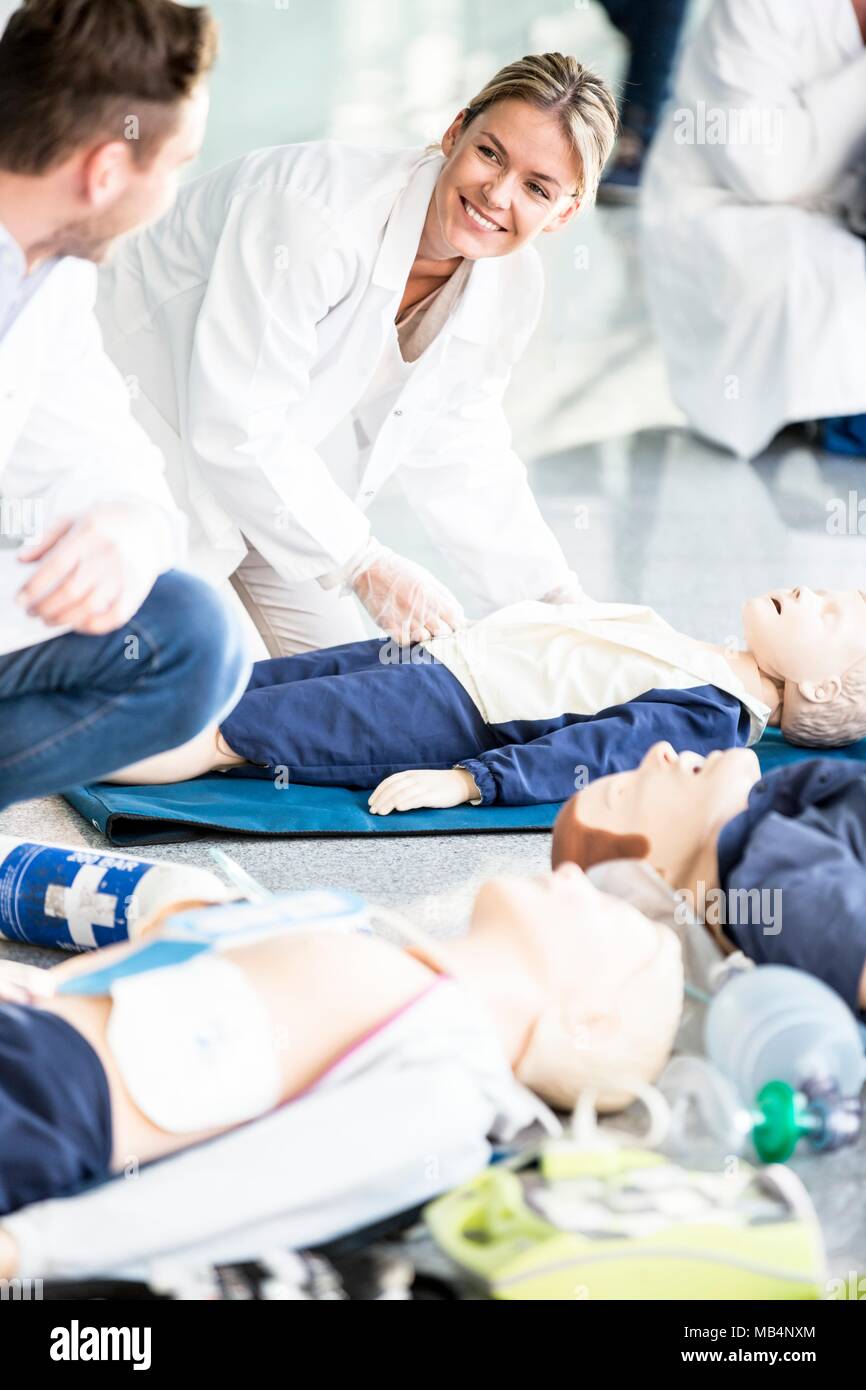 Doctors undertaking CPR training on dummies. Stock Photo