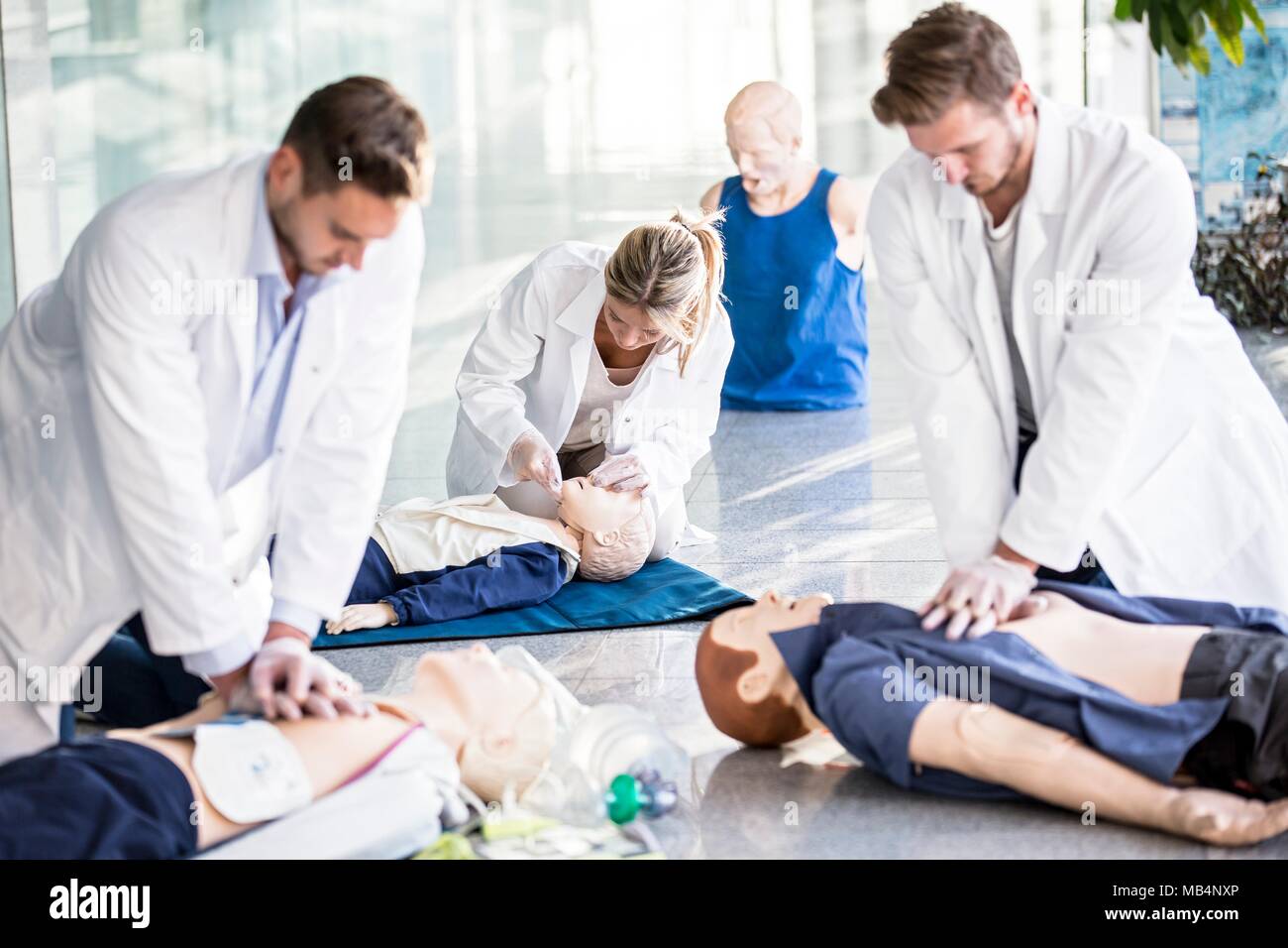 MODEL RELEASED. Doctors undertaking CPR training on dummies. Stock Photo