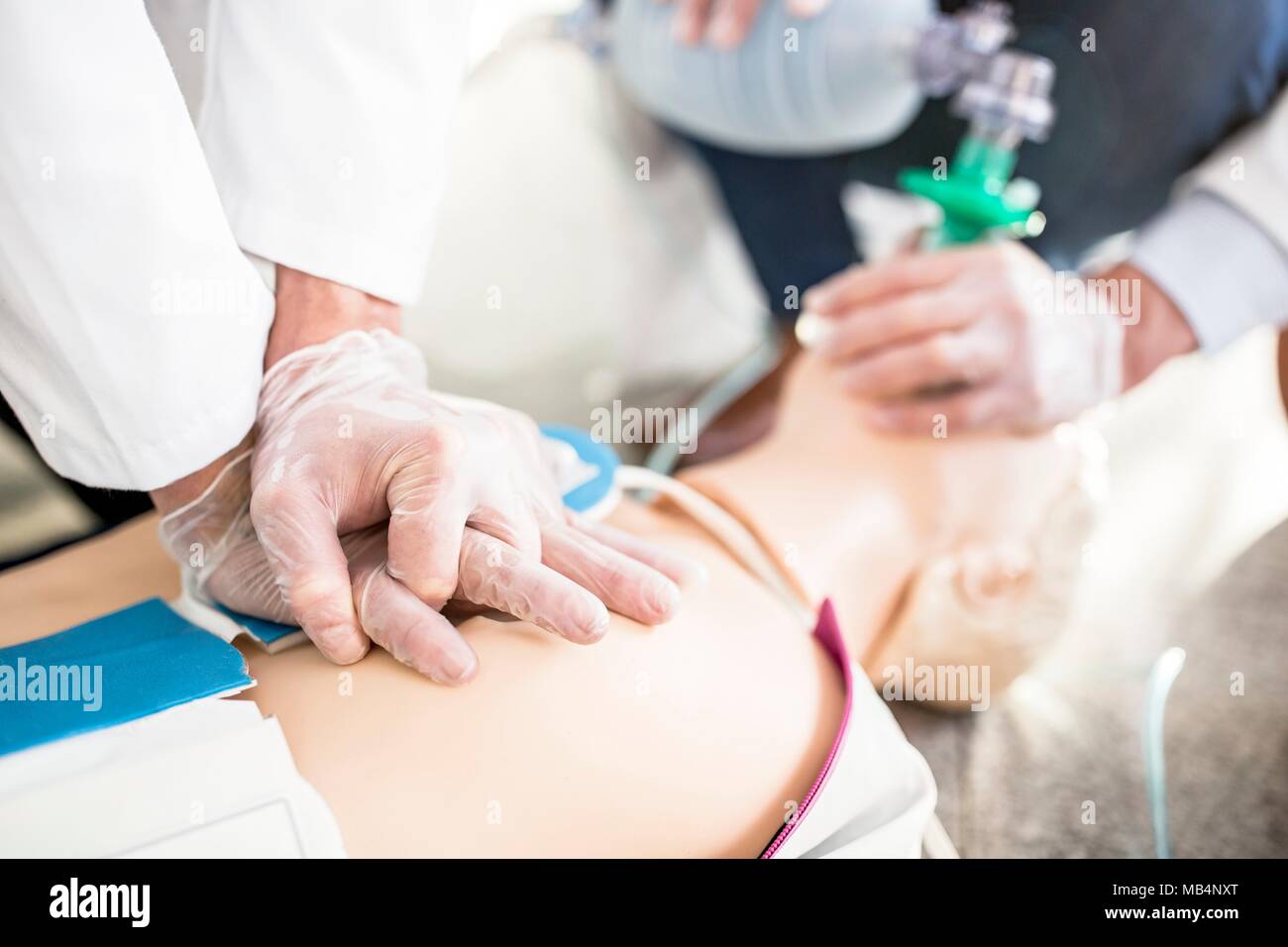 Doctors undertaking CPR training Stock Photo