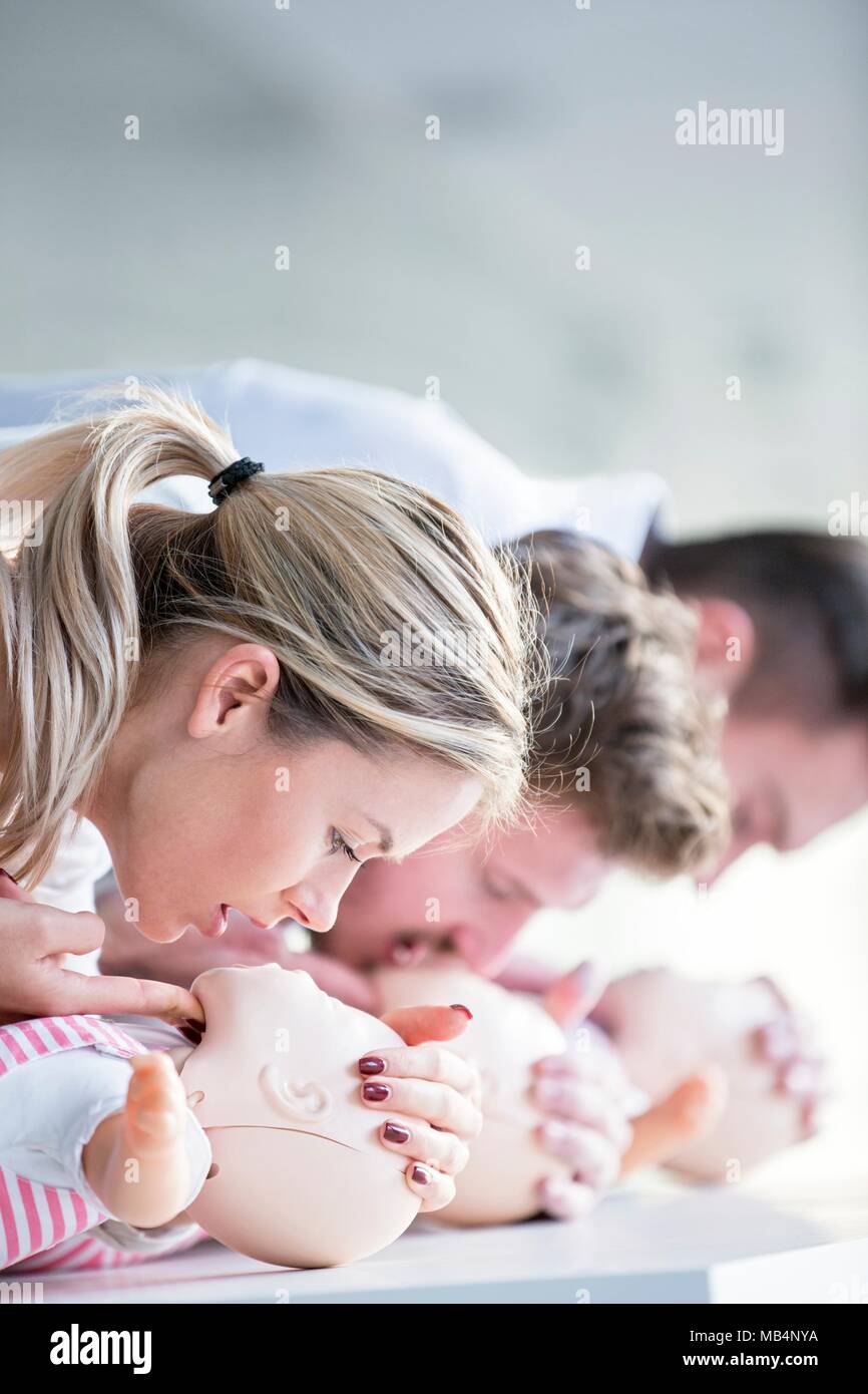 MODEL RELEASED. Doctor practising infant CPR on training dummies. Stock Photo