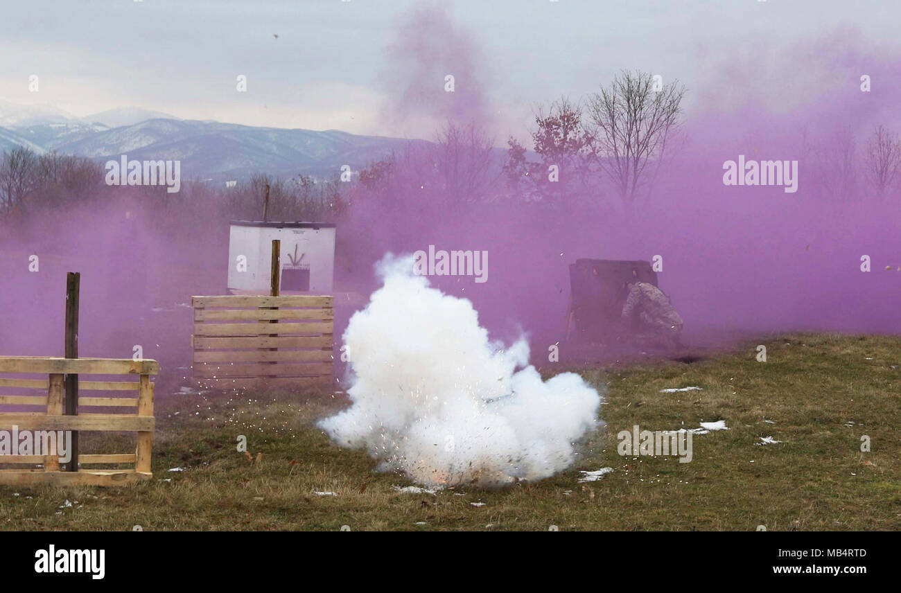 A MNBGEast Soldier prepares to throw a grenade at a target as