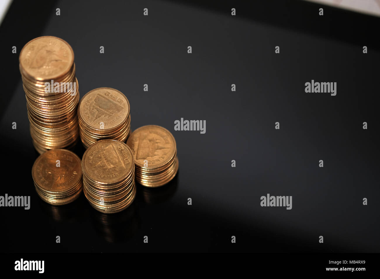 Step of coins stacks and tablet computer with financial graph, business ...