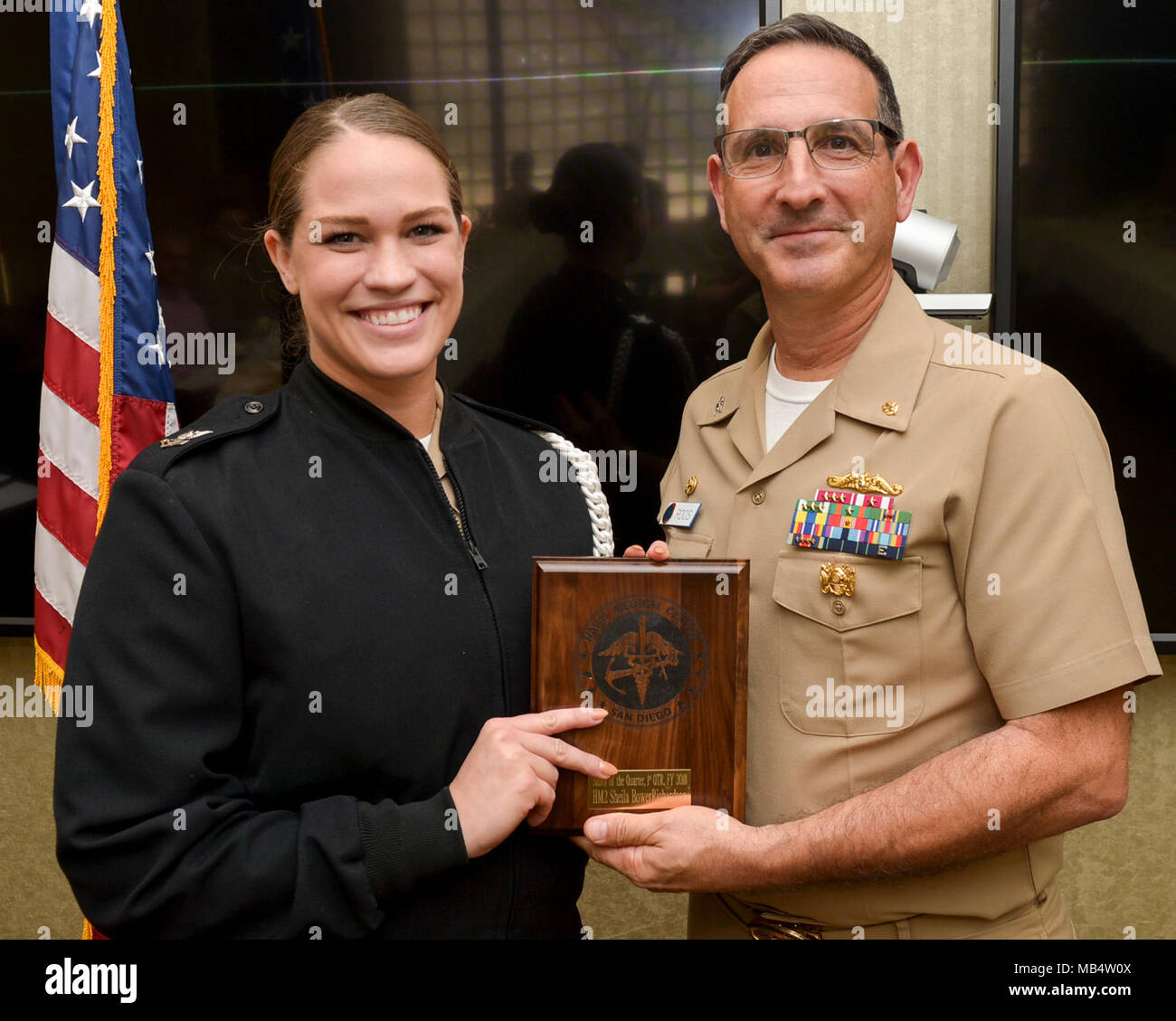 SAN DIEGO (Feb. 16, 2018) CAPT. Joel Roos, Naval Medical Center San Diego Commanding Officer,  presents Hospital Corpsman 2nd Class Shelia BowerRichardson with the Sailor of the Quarter award. H Hospital Corpsman 2nd Class BowerRichardson received the award for her exceptional work and devotion to duty. Stock Photo
