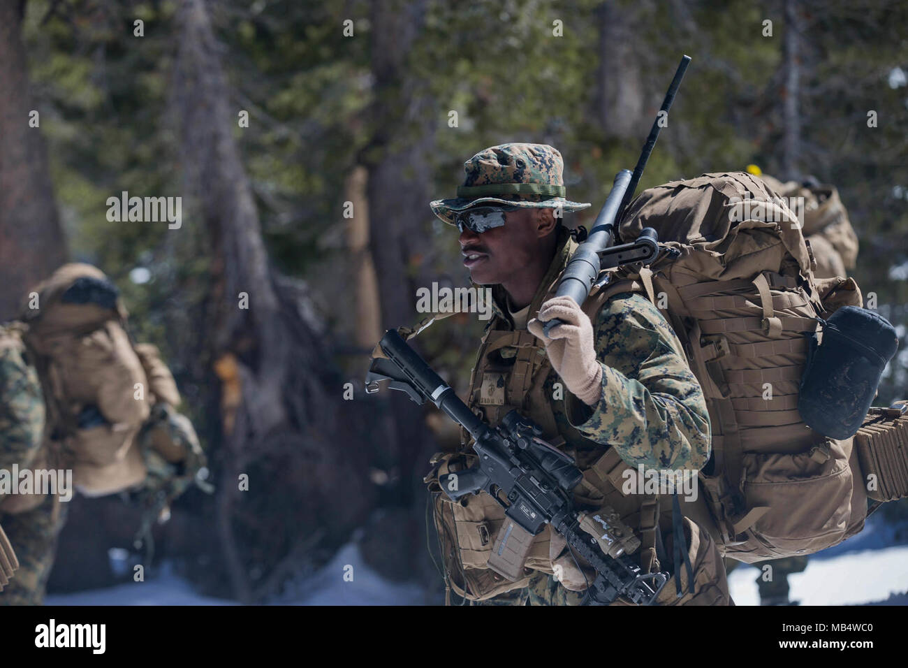 U.S. Marine Corps Sgt. Equan Etienne, squad leader with Kilo Company, 3rd Battalion, 8th Marines, 2nd Marine Division leads his squad during a tactical movement during Mountain Warfare Training (MTX) Bridgeport, C.A., Feb. 17, 2018. Marines with Kilo Co. finish up their month long exercise for MTX-18. Stock Photo