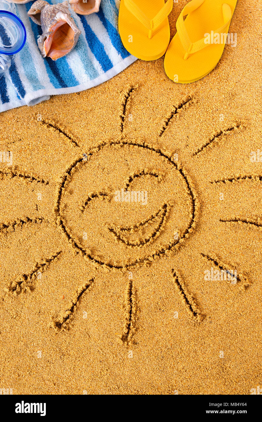 Smiley Face Sun Drawn In Sand On A Beach With Towel Seashells And Flip Flops Stock Photo Alamy