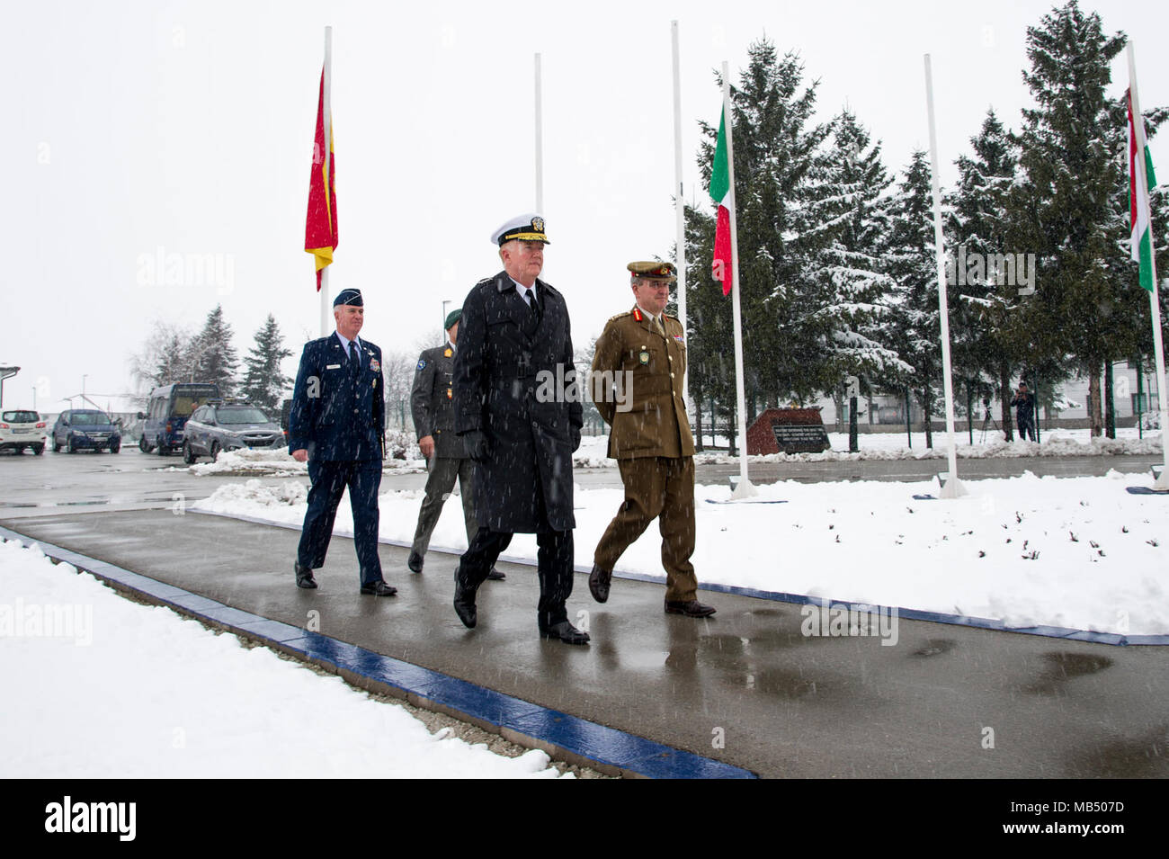 U.S. Navy Admiral James Foggo, U.K. Army General Sir James Everard, Austrian Army Maj. Gen. Anton Waldner, and U.S. Air Force Brig. Gen. Robert Huston march to inspect European soldiers during a welcome ceremony, Feb. 21, 2018 to the NATO and EUFOR Headquarters, Camp Butmir, Sarajevo. Foggo serves as Allied Joint Force Command Naples commander, Everard serves as NATO's Deputy Supreme Allied Commander Europe, Waldner serves as the European Union Force Althea commander, and Huston serves as the NATO Headquarters Sarajevo commander. Stock Photo
