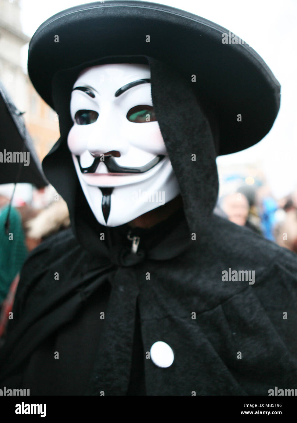 Man wearing the mask of Guy Fawkes V for Vendetta Stock Photo