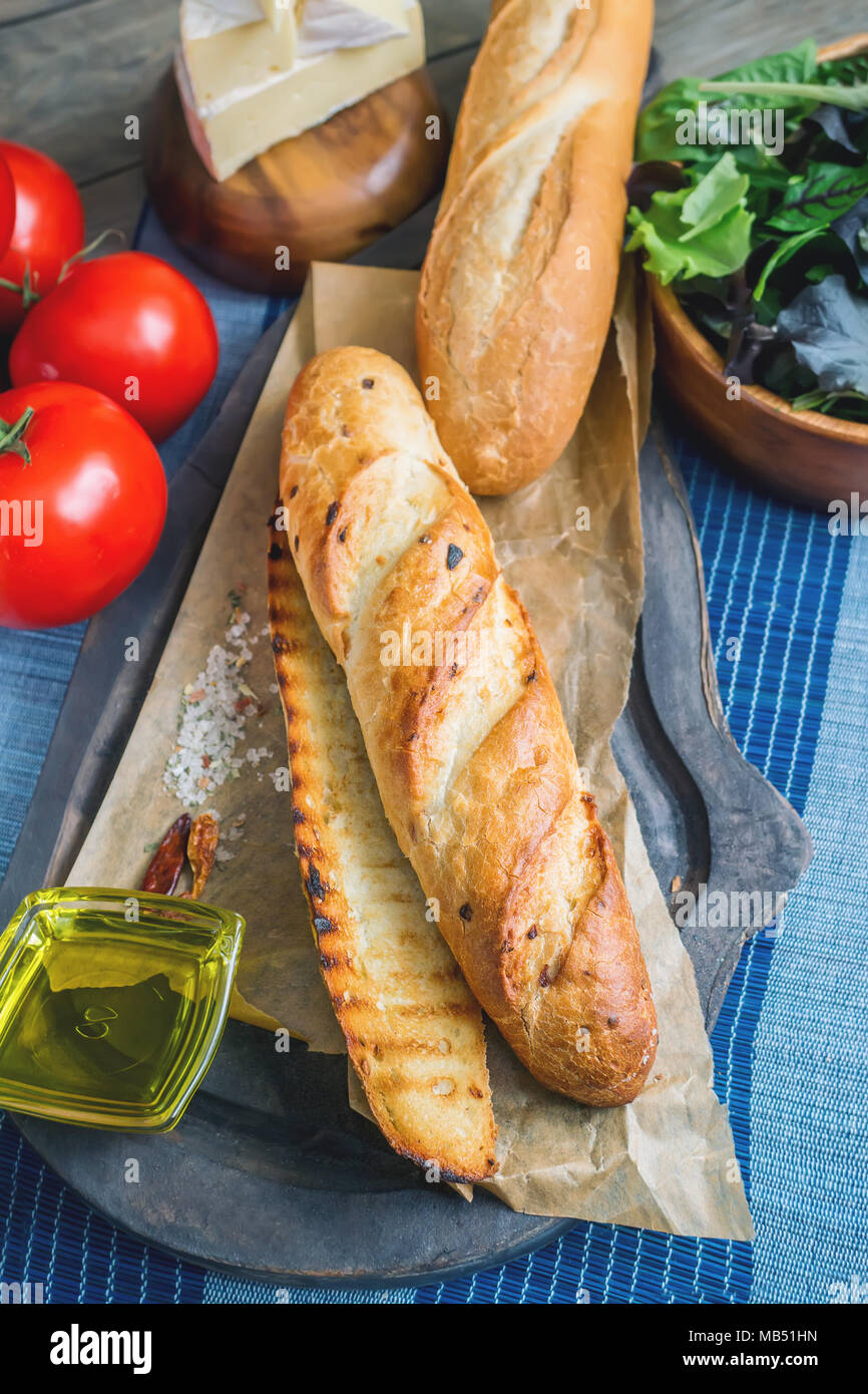 Baguette sandwich with lettuce and slices of fresh tomato. Preparation